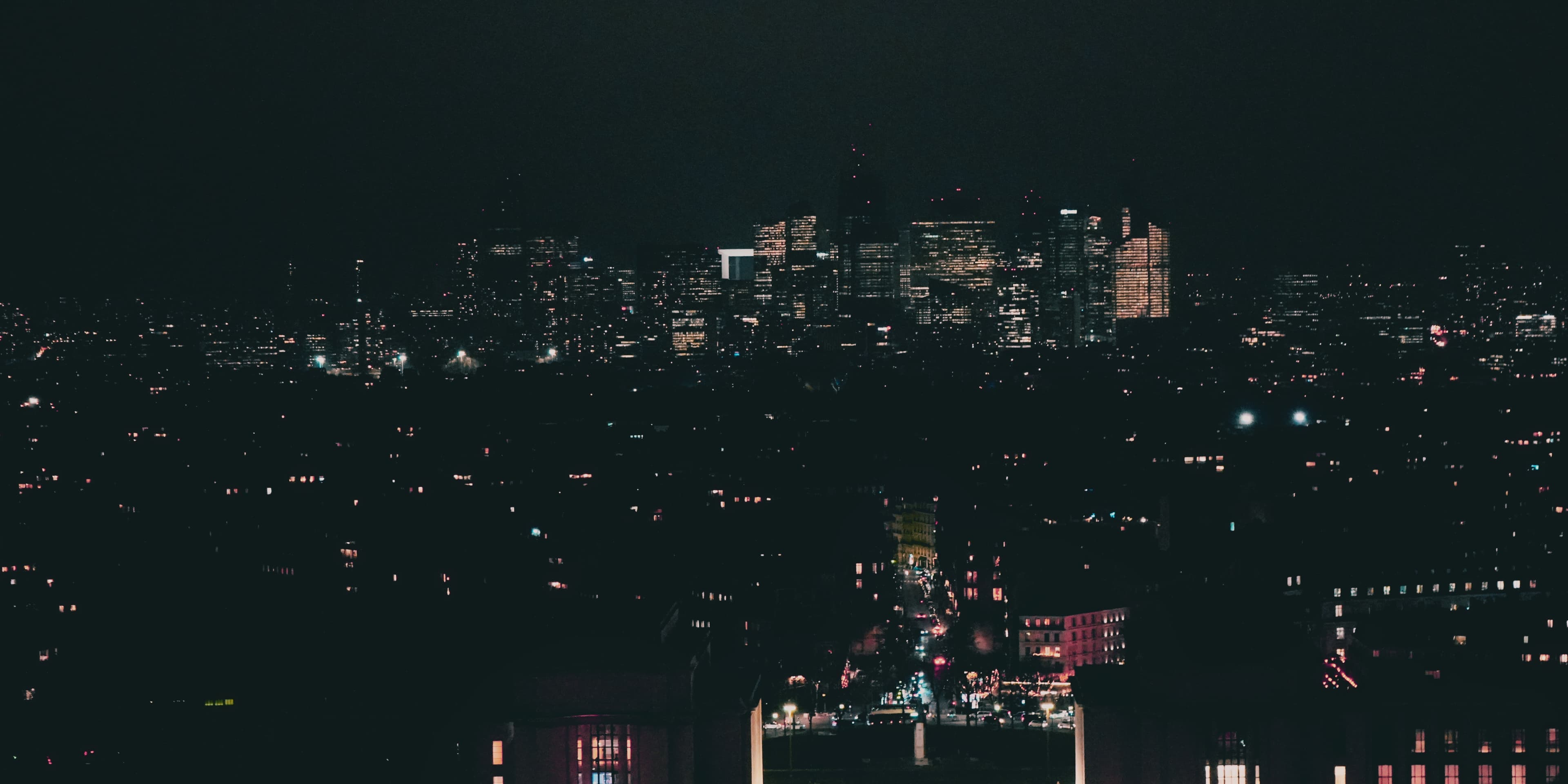 City lights reflected across water at night photographed by Eugene Truuts