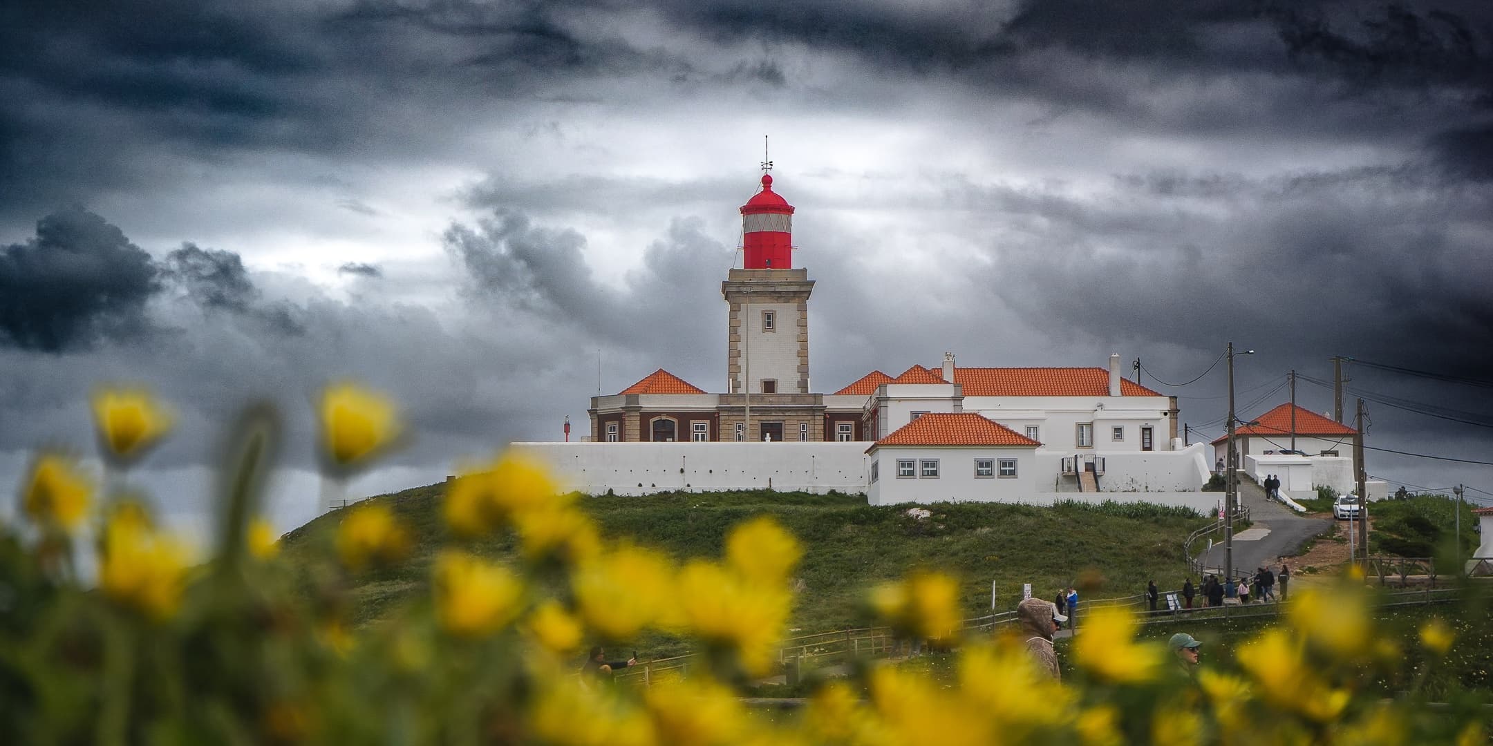 Coastal lighthouse beneath dramatic clouds photographed by Eugene Truuts