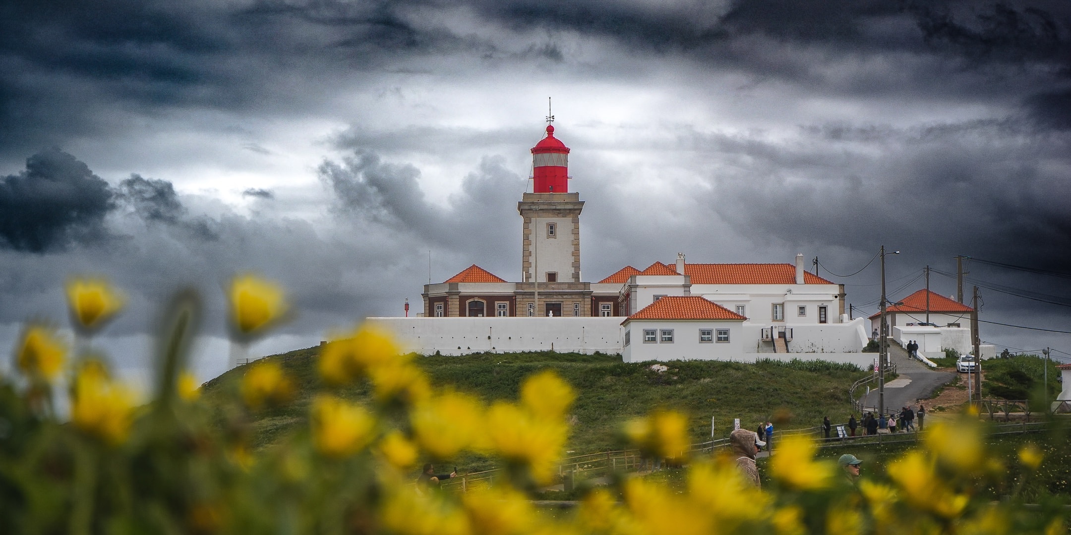 Coastal lighthouse beneath dramatic clouds photographed by Eugene Truuts