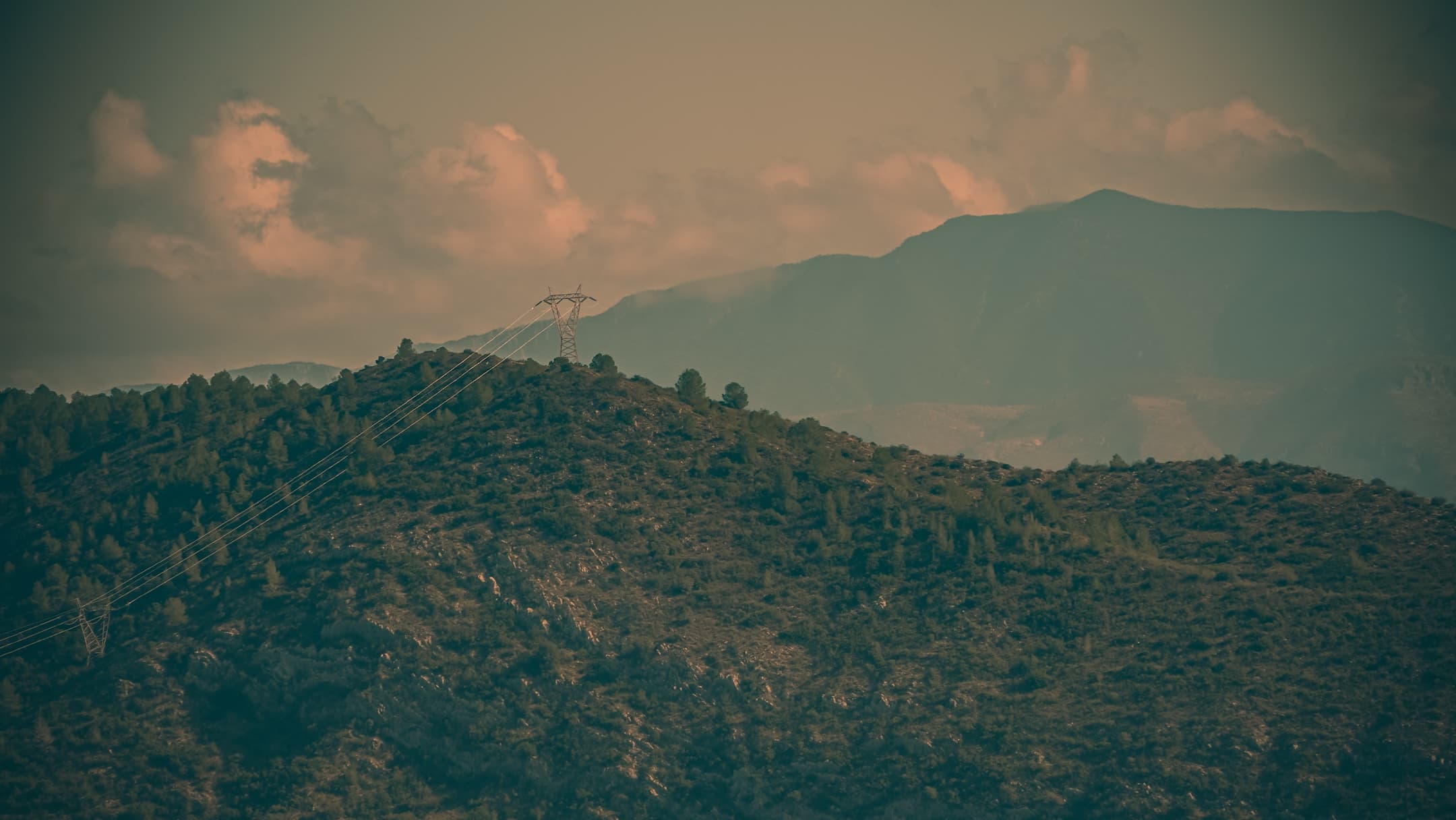 Distant mountains beneath sunlit clouds photographed by Eugene Truuts