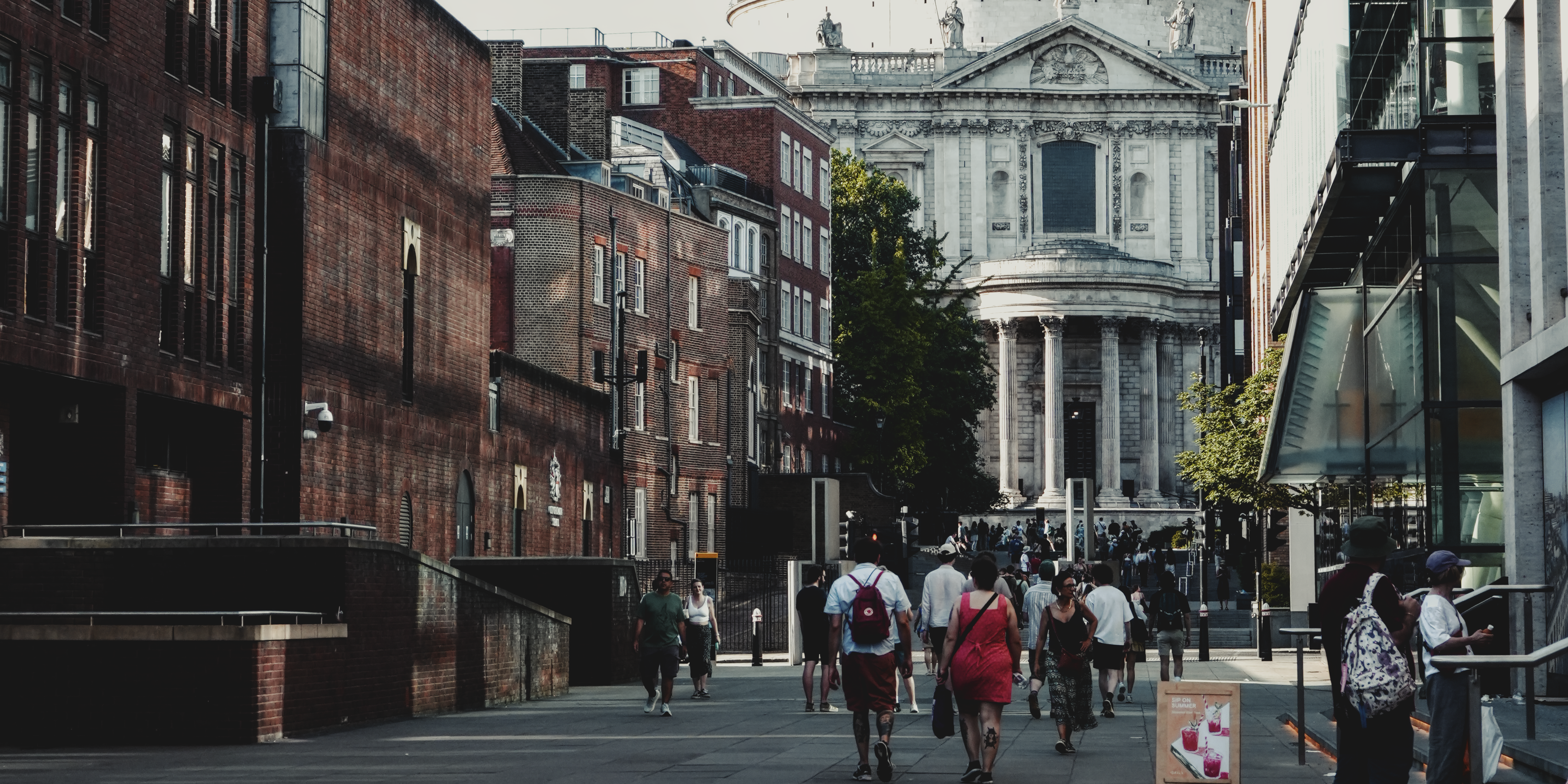 Pedestrians on a historic city street photographed by Eugene Truuts